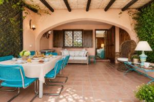 an outdoor patio with a table and chairs at Caprifogli Townhouse Close to the Beach in Baja Sardinia