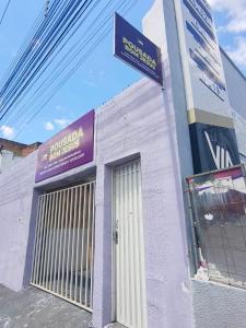 a building with a sign on the side of it at Pousada Bom Jesuss in Juazeiro do Norte