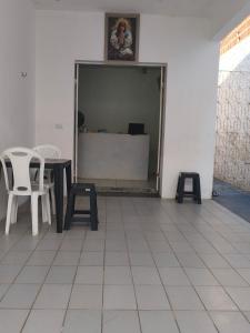 a room with a table and chairs and a counter at Pousada Bom Jesuss in Juazeiro do Norte