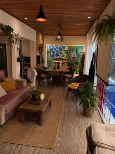 a living room with a couch and a table at Hostel do Mago in Pipa