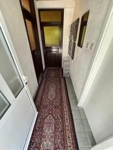 a hallway with a wooden door and a rug at Vikendica Vrba in Gacko