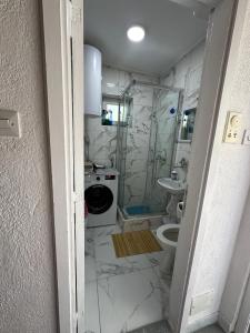 a bathroom with a shower and a toilet and a sink at Vikendica Vrba in Gacko +27 photos