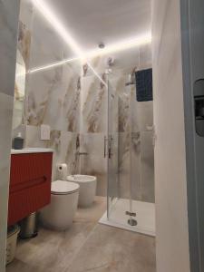 a bathroom with a shower and a toilet and a sink at SEA Studio Flat in Misano Adriatico +16 photos