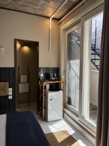 a bedroom with a bed and a large window at Synoikies by Oikieskiathos in Skiathos