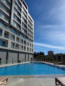 a large swimming pool next to a tall building at JoHa Stay in Bar