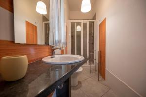 a bathroom with a sink and a toilet at Villa Fontane Bianche in Fontane Bianche +87 photos