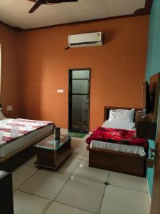 a room with two beds and a glass table at Amar mahal hotel and restaurant in Khātu