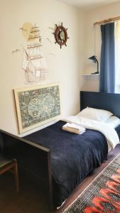 a bedroom with a bed with a clock on the wall at Happy One Park Apartment in Świdnica +48 photos