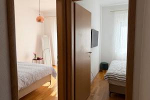 an open door to a bedroom with a bed at Boho Apartments in Trebinje