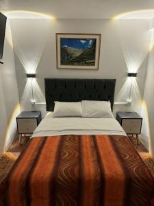 a bedroom with a large bed with two night stands at Hostal Mónaco in Machu Picchu +42 photos