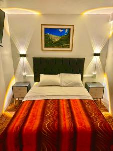 a bedroom with a large bed with two night stands at Hostal Mónaco in Machu Picchu