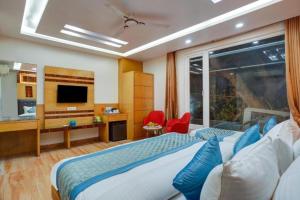 a hotel room with a bed and a television at Hotel Urban ECG Grand - Inn Near IGI Delhi Airport in New Delhi