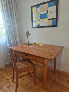 a wooden table with a lamp and two chairs at Bei Jakobus in Künzelsau +6 photos