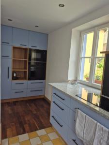 a kitchen with white cabinets and a counter top at Bei Jakobus in Künzelsau