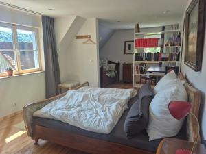 a bedroom with a bed and a book shelf at Bei Jakobus in Künzelsau