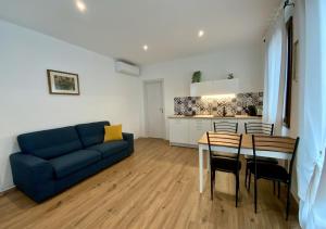 a living room with a blue couch and a table at Romantic suite between Venice and Padua in Dolo