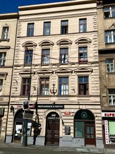 a large stone building on the corner of a street at Travel&Joy backpackers in Prague