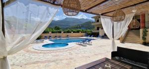 a view of a swimming pool with mountains in the background at Karras Apartments in Gliki