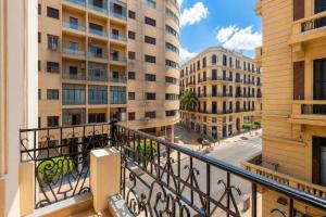 an apartment balcony with a view of a street and buildings at Malak Palace Cairo Hotel in Cairo