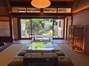 a living room with a couch and a table at New open - ねどことあさげナマケモノ Nedoko & Asage by Sloth - Japanese Traditional House in Ōno