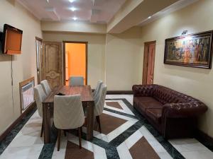 a living room with a table and a couch at Rahat Ev in Ganja