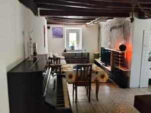 a living room with a table and a piano at Golden horses in Montebabbio