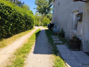 a dirt road next to a house and a building at Golden horses in Montebabbio