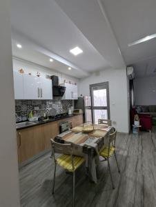 a kitchen with a table and chairs in a room at MahdiaRafeha in Mahdia +10 photos