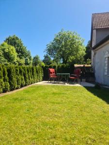 a patio with chairs and a table in a yard at Casa Mia in Goslar