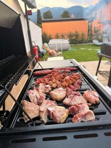 a grill with meat and other meats on it at Casa Hanna Garden in Verbania