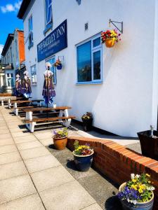 a building with potted plants in front of it at The Saltley Inn in Birmingham