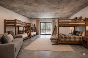 a living room with two bunk beds and a couch at Yellowstone Springs Resort in Island Park