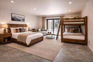 a bedroom with two bunk beds and a couch at Yellowstone Springs Resort in Island Park