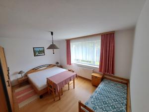 a small bedroom with a bed and a window at Graglerhof in Liebenfels +31 photos