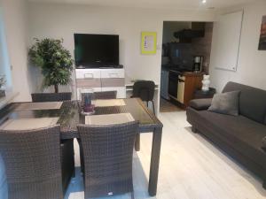 a living room with a table with chairs and a couch at Ferienhaus Congolo in Lontzen