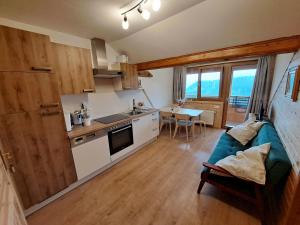 a kitchen and living room with a couch and a table at Graglerhof in Liebenfels