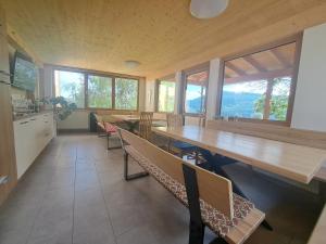 a large room with tables and chairs and windows at Graglerhof in Liebenfels