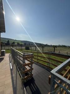 a wooden deck with a fence and a view of a field at Oasi Frontemare Appartamenti in Pineto