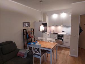 a living room with a table and a kitchen at NordseeGlück in Cuxhaven