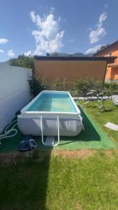 a swimming pool in the grass in a backyard at Casa Hanna Garden in Verbania