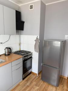 a kitchen with a stainless steel refrigerator and a stove at Daniel Apartment in Reda