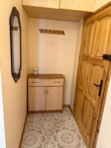 a room with a wooden door and a tiled floor at Daniel Apartment in Reda
