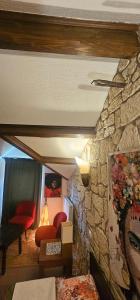 a living room with a stone wall at LES GARGOUILLES - Piscine à Débordement Avec Vue Exceptionnelle - Gorges du Tarn - Millau in Boyne +49 photos