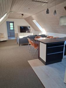 a living room with a couch and a table and chairs at Bakkely in Rønnede