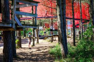 a young girl swinging a bat at a park at Bakkely in Rønnede