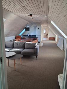 a living room with a couch and a table at Bakkely in Rønnede
