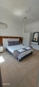 a bedroom with a large bed in a room at Bena pansiyon in Fethiye