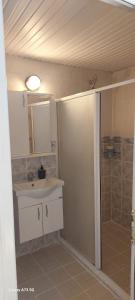 a bathroom with a shower and a sink and a mirror at Bena pansiyon in Fethiye