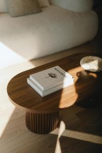 a book sitting on a wooden table on a table at Kasa Dharma an oceanfront House in El Suazal