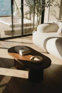 a living room with a coffee table and a couch at Kasa Dharma an oceanfront House in El Suazal